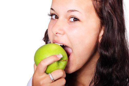 Mulher comendo uma maçã