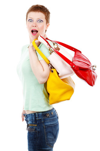 Surprised woman carrying bags