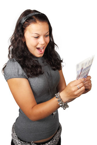 Thrilled teenage girl with money