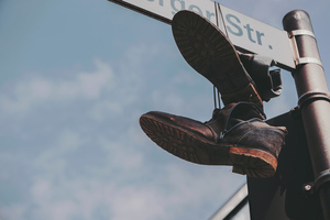 Shoes hanging on a street sign