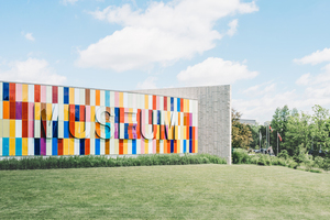 Colorful museum sign in front of grass