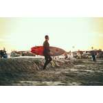 Surfer carrying surfboard