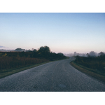 Road through misty landscape