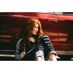 Girl sitting by the car