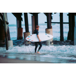 Bearded surfer heading into water