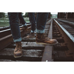 Male boots on railway